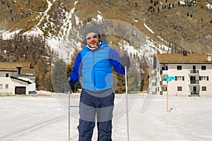Lifestyle portrait of young happy and attractive man doing cross country ski enjoying winter holidays on Swiss Alps having fun on