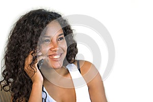 Lifestyle portrait of young happy and gorgeous black hispanic woman talking on mobile phone at home living room sofa couch enjoyin