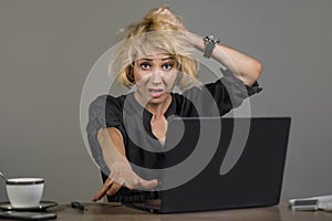 Lifestyle portrait of young stressed and messy business woman working at office laptop computer desk feeling tired and overwhelmed