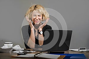 Lifestyle portrait of young stressed and messy business woman working at office laptop computer desk feeling tired and overwhelmed