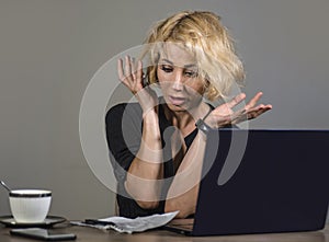 Lifestyle portrait of young stressed and messy business woman working at office laptop computer desk feeling tired and overwhelmed