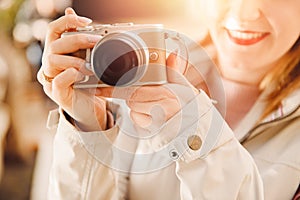 Lifestyle portrait of young Woman photographer with camera in journey makes photo