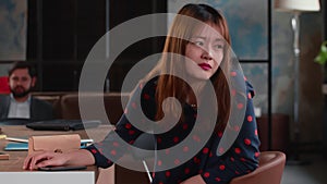 Lifestyle side view portrait of beautiful young confident gen-z Asian IT business woman talk to colleagues at office.