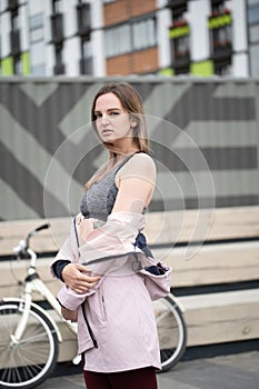 Lifestyle sport concepte. Portrait of young woman with vintage bike in city parking. Nature color toning for design