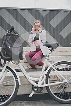 Lifestyle sport concepte. young woman with vintage bike in city parking. Nature color toning for design