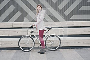 Lifestyle sport concepte. young woman with vintage bike in city parking. Nature color toning for design