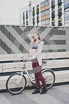 Lifestyle sport concepte. young woman with vintage bike in city parking. Nature color toning for design