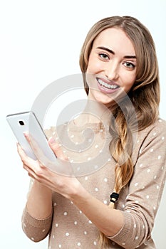 Lifestyle stylish girl using phone texting on smartphone app. Face with toothy smile. Beauty stylish blonde woman with pink lips