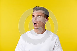 Lifestyle, summer and people emotions concept. Close-up portrait of disappointed sad and tired young man in white t