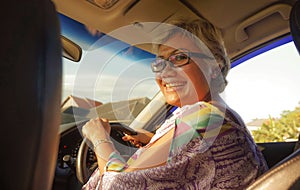 Lifestyle Summer portrait of middle aged happy and attractive classy Asian Indonesian woman driving left hand car smiling cheerful
