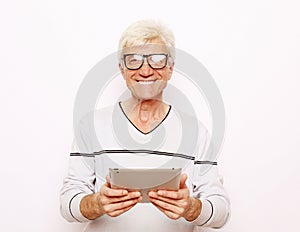 Lifestyle, tehnology and people concept: Happy senior man using digital tablet.