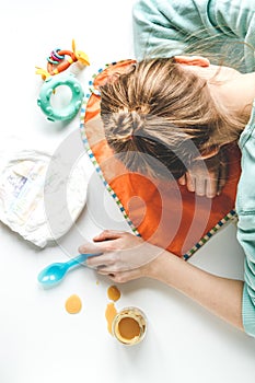 Lifestyle tired mother top view on white background