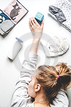 Lifestyle tired mother top view on white background