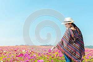 Lifestyle traveler women raise hand feeling good relax and happy freedom on the meadow nature cosmos farm in the sunrise morning.