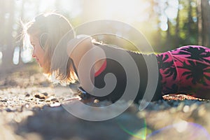 Lifestyle wearable technology shot with lensflare. Athlete wearing smart watch doing push ups