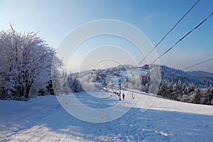 The lift cableway and a lot of skiers