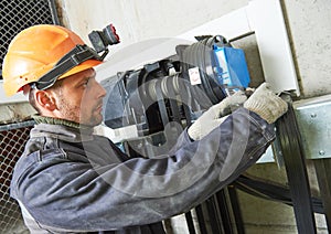 Lift machinist repairing elevator in lift shaft