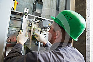 Lift machinist repairing elevator in lift shaft