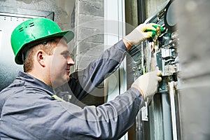 Lift machinist repairing elevator in lift shaft