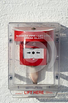 A lift and press fire alarm on the outside of a building