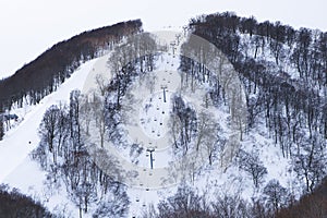 Lift or ropeway skiing snow. Scenic cable car flying over piste snow covered mountain.