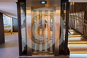 Lift with transparent glass doors in modern building