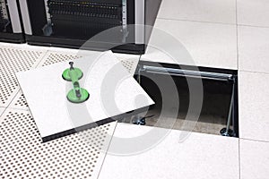 Lifted Datacenter Floor Tile With Vacuum Suction Cups In Datacenter photo