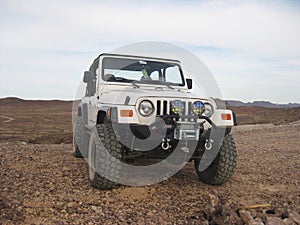 Lifted White Jeep 2002 Wrangler Parked on Dirt in Arizona Desert