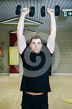 Lifting dumbbells. Physical exercises with a weight of 15 kg.