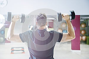 Lifting dumbbells. Physical exercises with a weight of 15 kg.