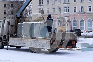 Lifting a large ice cube water white winter