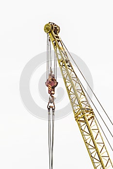 Lifting mechanism of the machine bridge crane with steel cable and hook on a white background