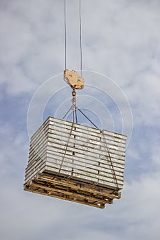 Lifting pallet with formwork elements by crane 2