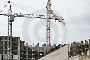 Lifting tower cranes on frame of frame building