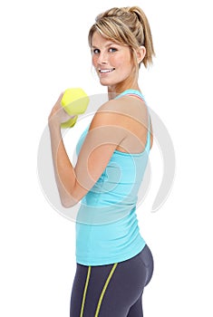 Lifting weights and feeling great. Attractive young woman in sportswear lifting dumbbells while isolated on white.