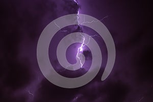 Lighning bolt over night sky in central europe. Huge lightning in a purple clouds at night. Night storm with lightnings