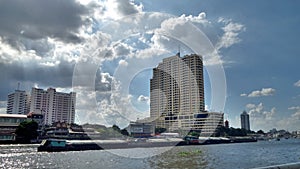 Light from above through white cloud on the building and river