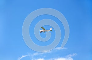 Light aircraft on blue sky as background