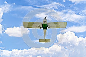 Light aircraft flying over blue sky. Single-engine