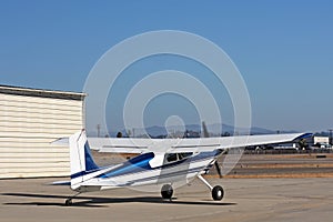 Light aircraft in front of hangar