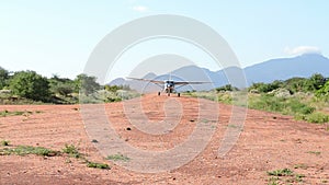 Light aircraft lands on sandy runway
