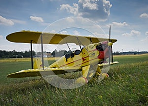 Light aircraft. Light yellow airplane on airport grass. Light general aviation plane on final