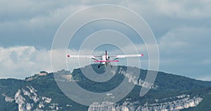 Light Aircraft Takes off with Mountains in Background