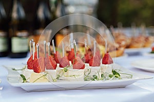 Light appetizer cheese and strawberries for guests at a wedding buffet. Waiting for a wedding ceremony