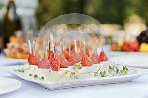 Light appetizer cheese and strawberries for guests at a wedding buffet. Waiting for a wedding ceremony