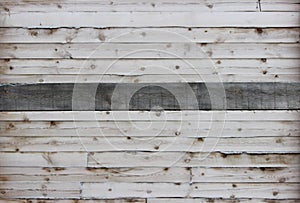 light background of old boards and one gray board in the middle in the center