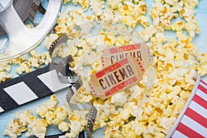 On a light background, scattered popcorn, two movie tickets, double for filming and film