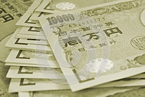 Light background on the theme of banks, finance and the economy of Japan. Japanese paper money. Tinted green or olive backdrop