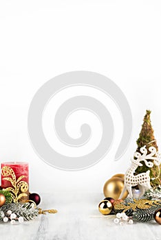 On a light background there is a small Christmas tree, a candle and New Year\'s decor.