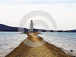 The light of the beacon guides sailors towards the shore